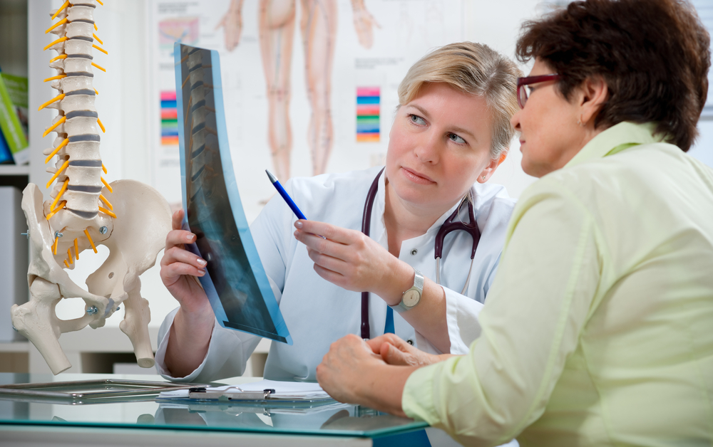Doctor explaining xray scan to injured patient