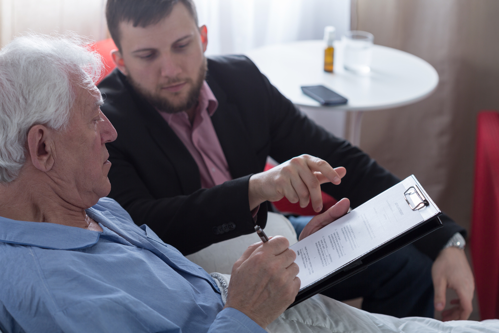 lawyer presenting patient with paperwork